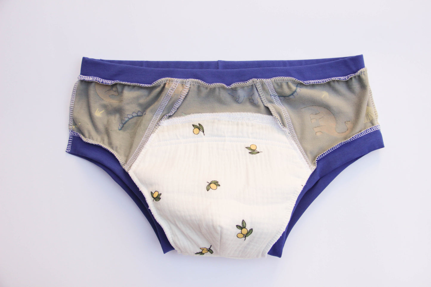 ABDL training pants for adult Dino on a gray background