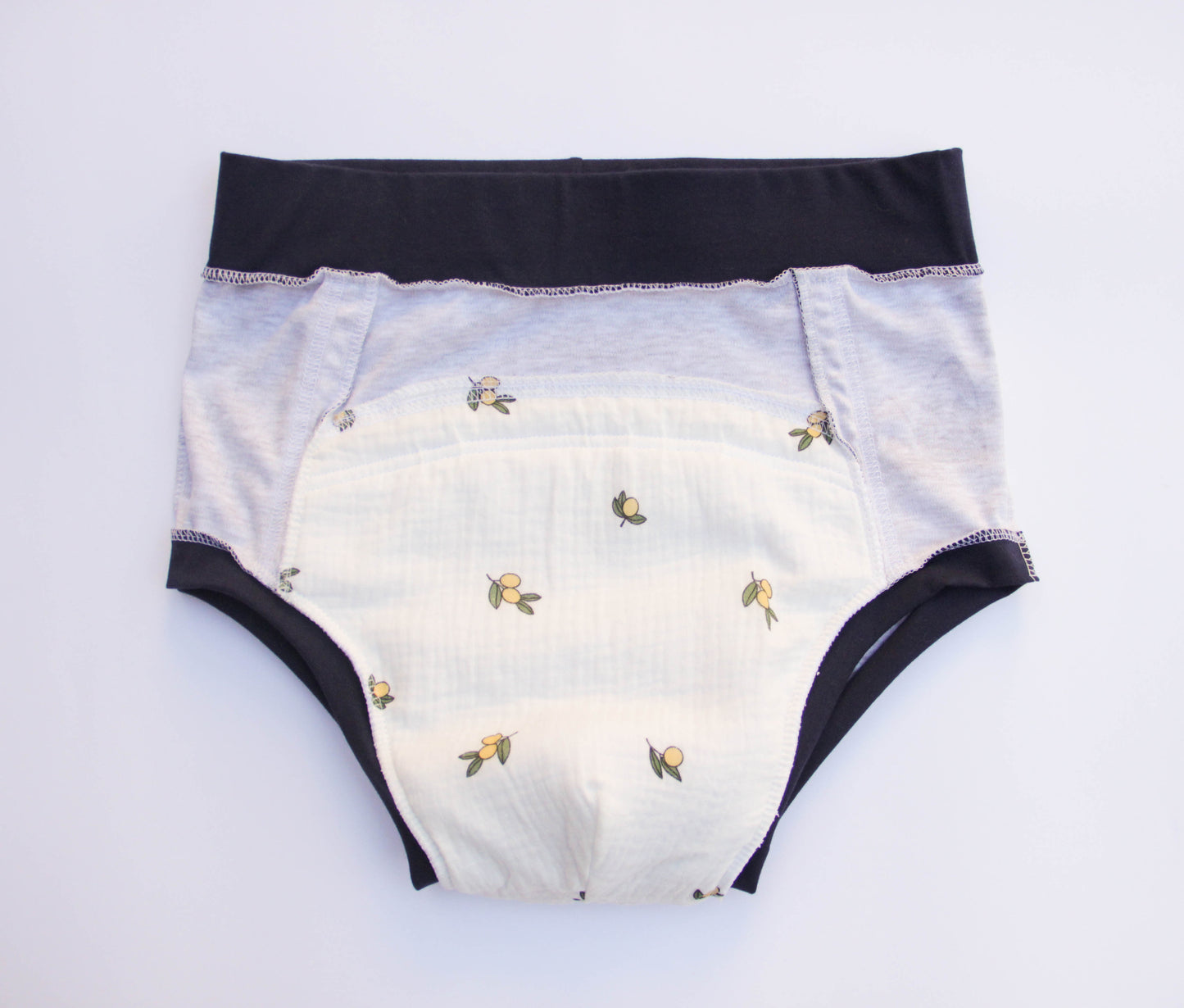 ABDL training pants for adult Dino on a gray background