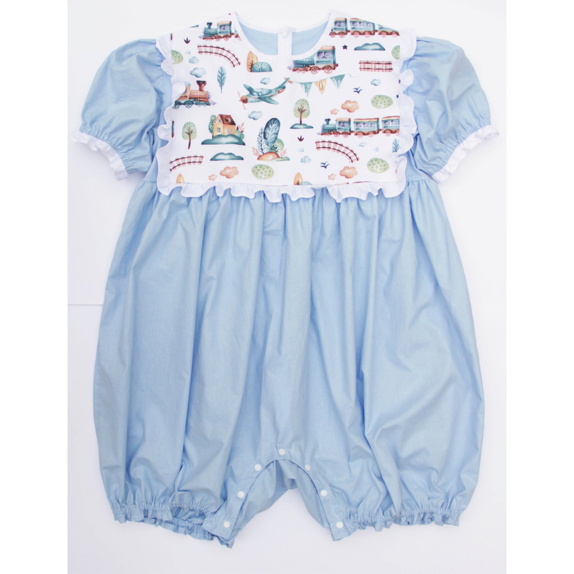 Light blue baby romper with a colorful printed top on a white background